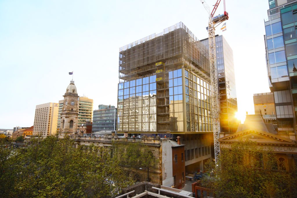 Project progress image at sunset shows façade well underway reaching up to level 9 of 15